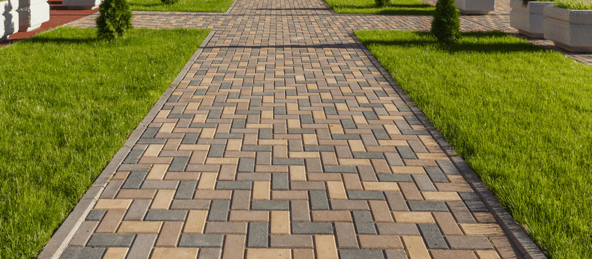 Brick pathway surrounded by green grass.