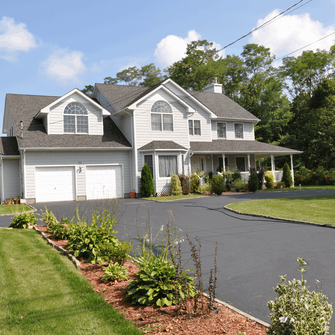 Large suburban house with driveway and garden.
